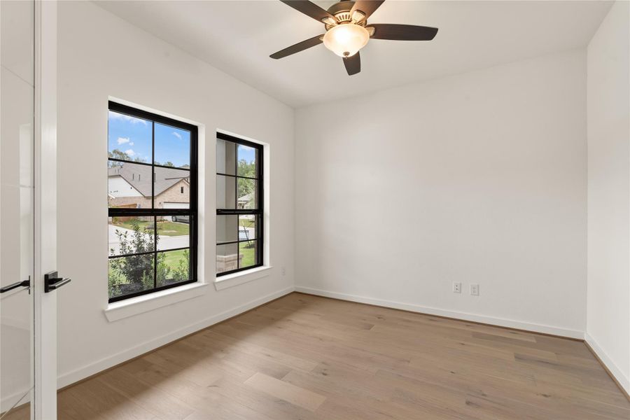 *REPRESENTATION PHOTO OF THE SAME FLOOR PLAN, FINISHES WILL VARY* Formal office enclosed by double french doors.