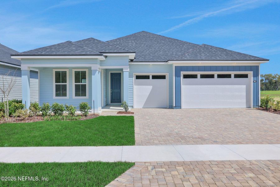 Front exterior of a new home in Veranda Bay, Flagler Beach, FL, highlighting curb appeal (Image 26).