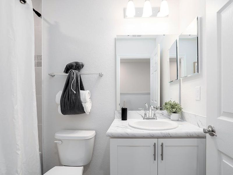 An upstairs hall bath serves your secondary bedrooms - Azalea townhome by Highland Homes