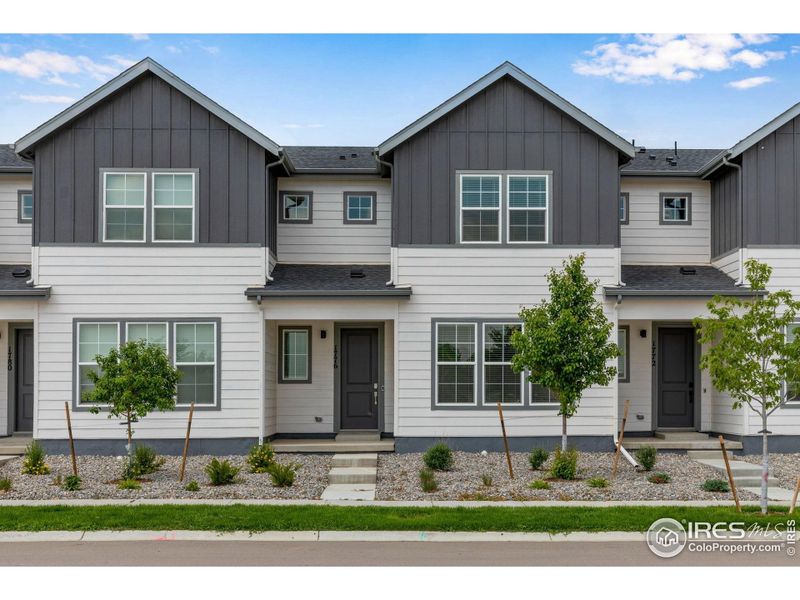 Front exterior of a new home in Westside Crossing Townhomes, Berthoud, CO, highlighting curb appeal (Image 22).