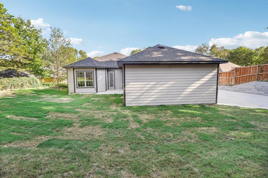 Back of property with a patio area and a yard