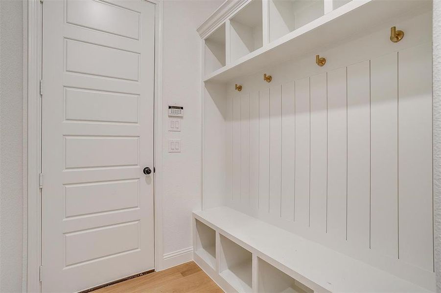 Mudroom with light hardwood / wood-style floors