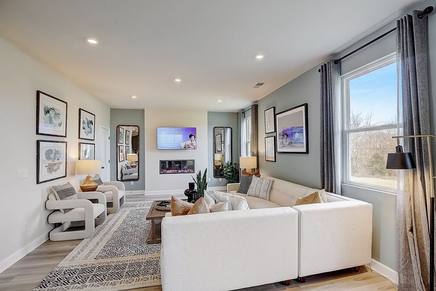 A living room with a white couch and a white table. A living room with a white couch and a white table.