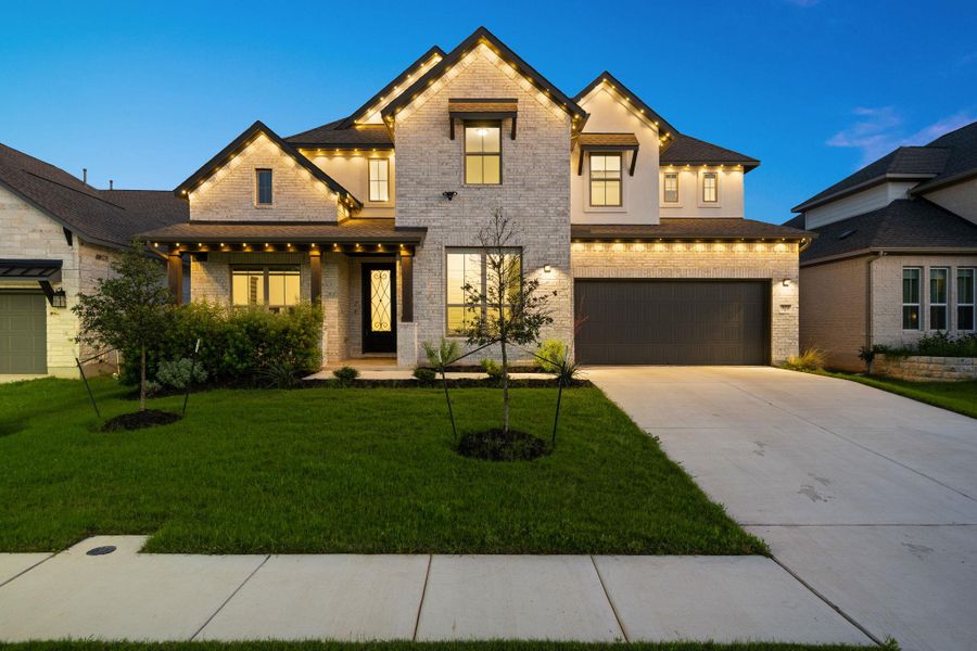 A striking modern residence boasts an inviting entry, well-kept landscaping, and a dual garage at dusk. A striking modern residence boasts an inviting entry, well-kept landscaping, and a dual garage at dusk.