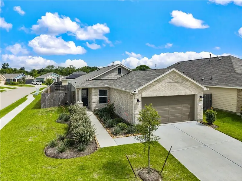 Front exterior of a new home in Mustang Crossing, Alvin, TX, highlighting curb appeal (Image 27).
