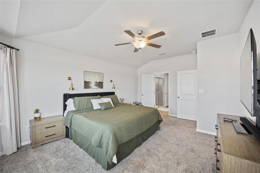 Bedroom featuring lofted ceiling, light carpet, and ceiling fan