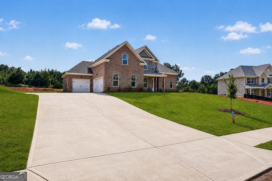 Front exterior of a new home in Patillo Manor, Stockbridge, GA, highlighting curb appeal (Image 19).