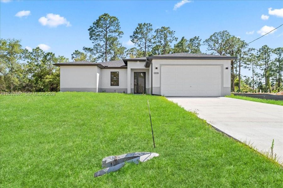 Front exterior of a new home in , Lehigh Acres, FL, highlighting curb appeal (Image 19). Front exterior of a new home in , Lehigh Acres, FL, highlighting curb appeal (Image 19).