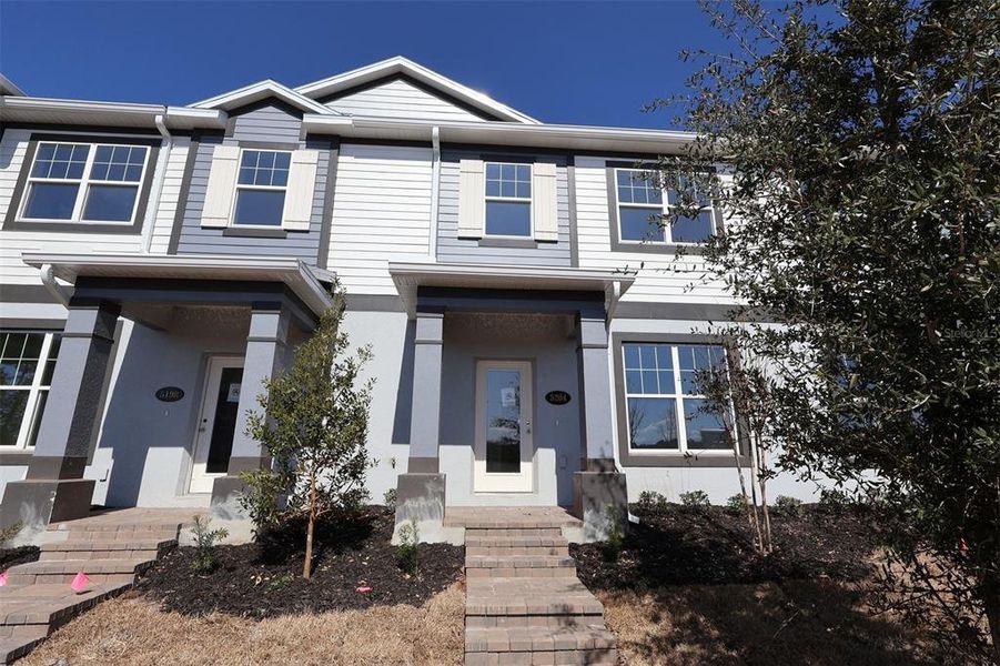 Front exterior of a new home in Center Lake on the Park, St. Cloud, FL, highlighting curb appeal (Image 7).