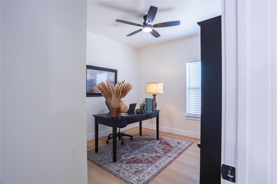 Bedroom with closet / Office with light wood finished floors and ceiling fan