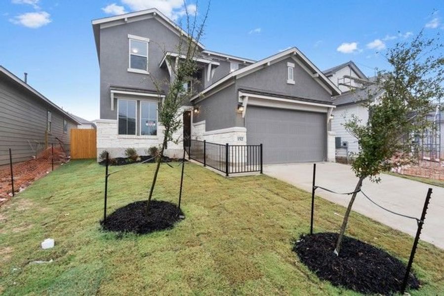 Front exterior of a new home in Morningstar, Georgetown, TX, highlighting curb appeal (Image 5).