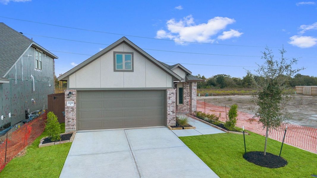 Front exterior of a new home in Creekhaven, Rosharon, TX, highlighting curb appeal (Image 14).