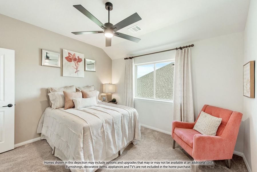 Bedroom with vaulted ceiling, ceiling fan, carpet floors, and a coral accent chair near the window Bedroom with vaulted ceiling, ceiling fan, carpet floors, and a coral accent chair near the window