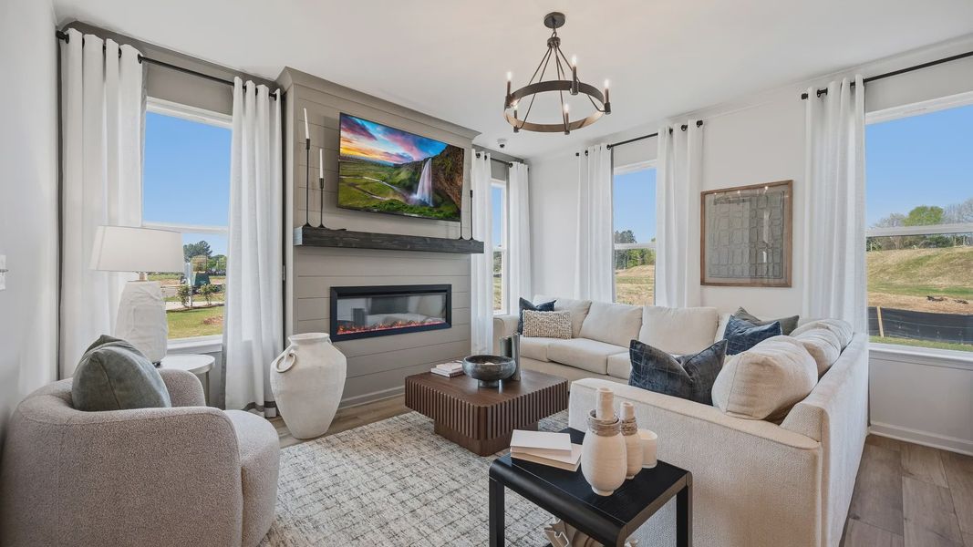 Spacious family room with electric fireplace, large windows, and open layout in Langley Overlook townhome in Loganville, GA. Spacious family room with electric fireplace, large windows, and open layout in Langley Overlook townhome in Loganville, GA.