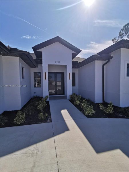 Front exterior of a new home in , Cape Coral, FL, highlighting curb appeal (Image 24).