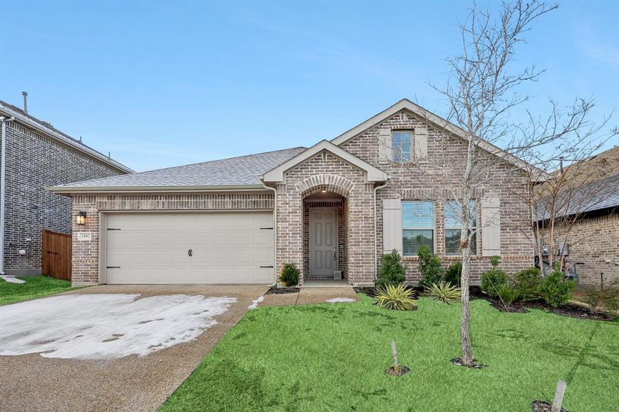 View of front of house with a front lawn and a garage