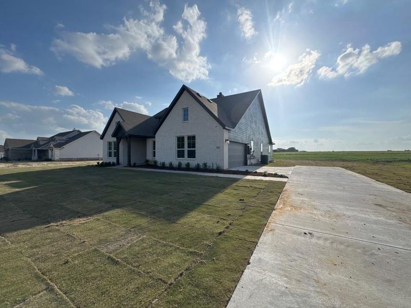 Front exterior of a new home in Terra Escalante, Blue Ridge, TX, highlighting curb appeal (Image 18).