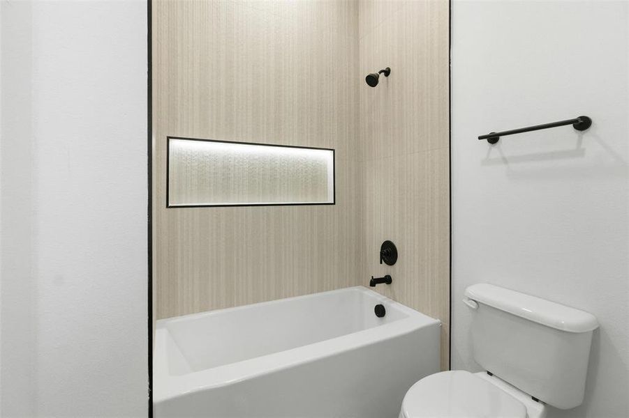 Bathroom with toilet and shower / bath combination