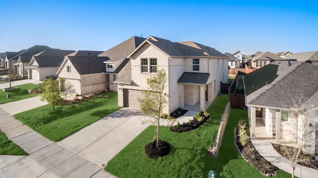 Front exterior of a new home in Reunion, Rhome, TX, highlighting curb appeal (Image 22).