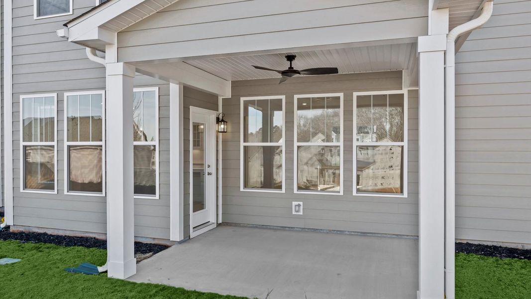 Refined rear exterior with a stylish covered porch for dining, relaxing, or entertaining