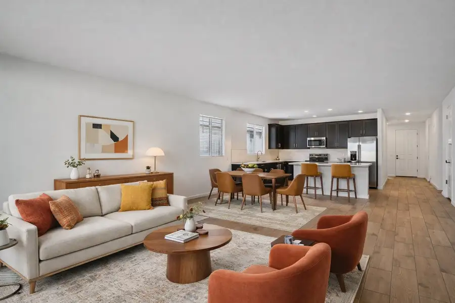 Great room, dining and kitchen. Virtually staged. Finishes may vary by community.