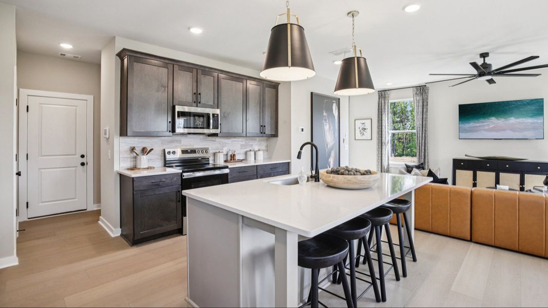 Kitchen island view of garage access door and living room