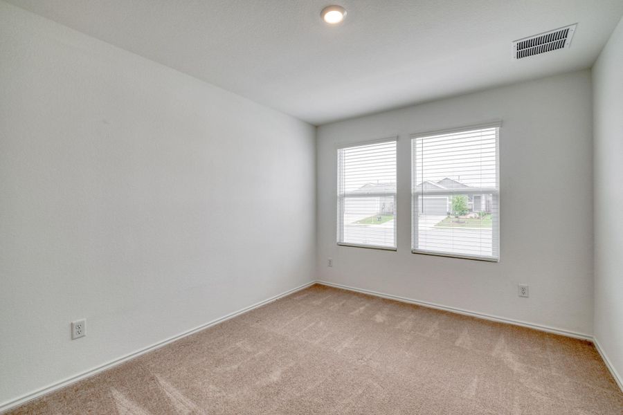 Neutral wall paint with two windows featuring blinds