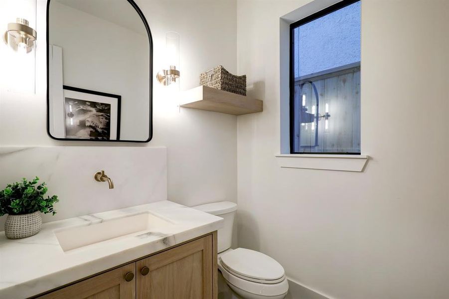 Welcome guests in this conveniently located first-level powder room near the front entrance.