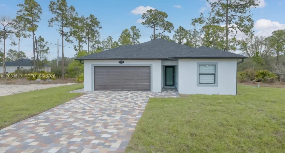 Front exterior of a new home in , Lehigh Acres, FL, highlighting curb appeal (Image 14).