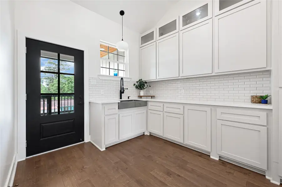Abundant cabinetry offers ample storage in this bright, modern kitchen.