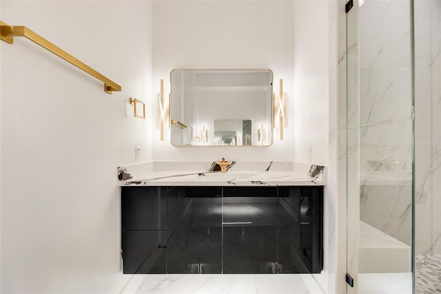 Bathroom with vanity and a marble finish shower Bathroom with vanity and a marble finish shower