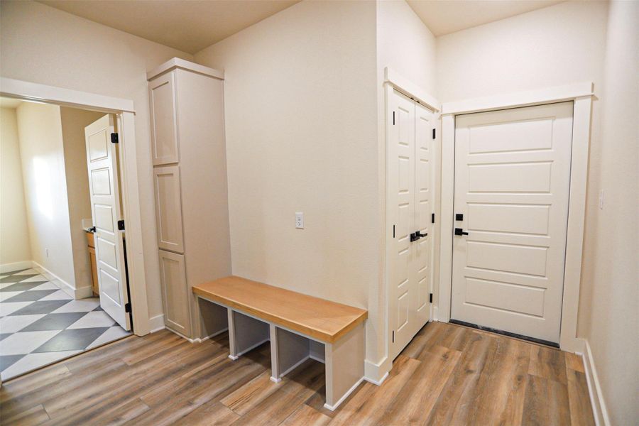 Mudroom featuring baseboards and light wood-style flooring