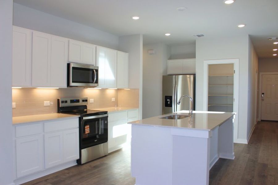 A kitchen with white cabinets. A kitchen with white cabinets.