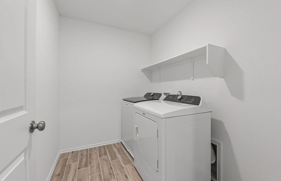 Laundry room with wood tiled floors and independent washer and dryer Laundry room with wood tiled floors and independent washer and dryer