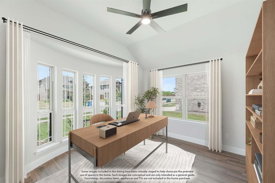 Home office with vaulted ceiling, ceiling fan, wood desk, and large windows with white curtains Home office with vaulted ceiling, ceiling fan, wood desk, and large windows with white curtains