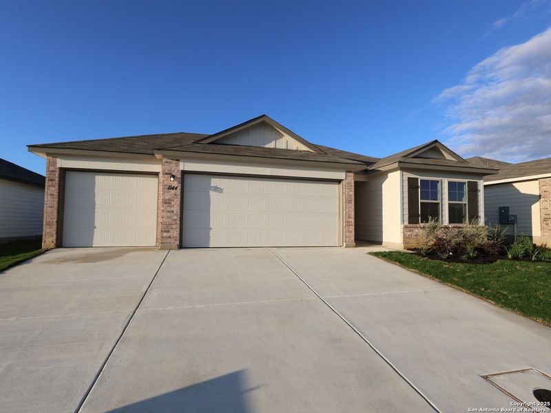 Front exterior of a new home in Greenspoint Heights, Seguin, TX, highlighting curb appeal (Image 2).