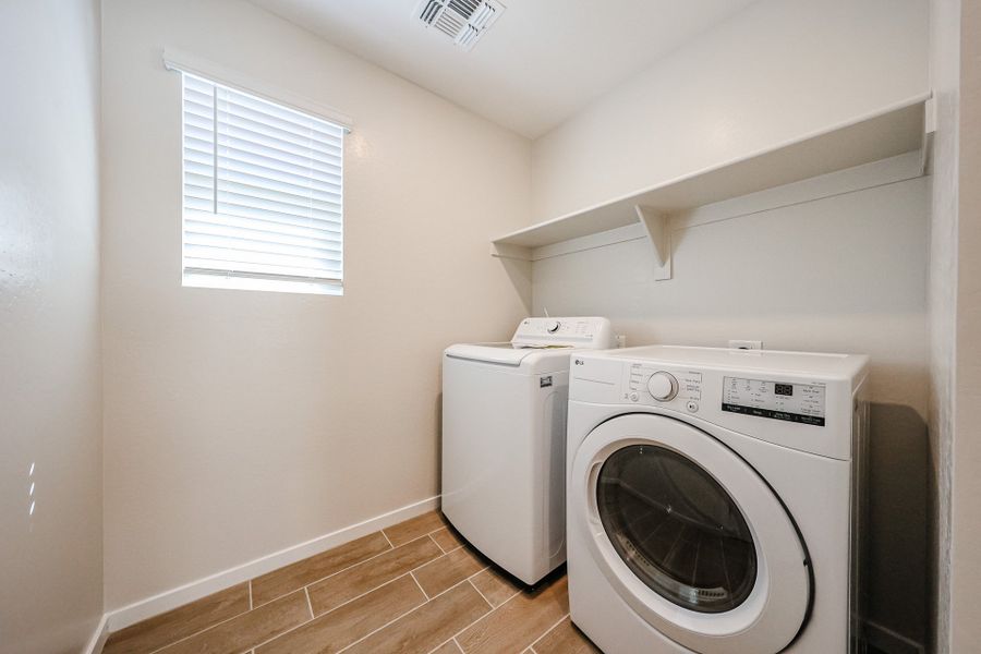 A washing machine in a room. A washing machine in a room.