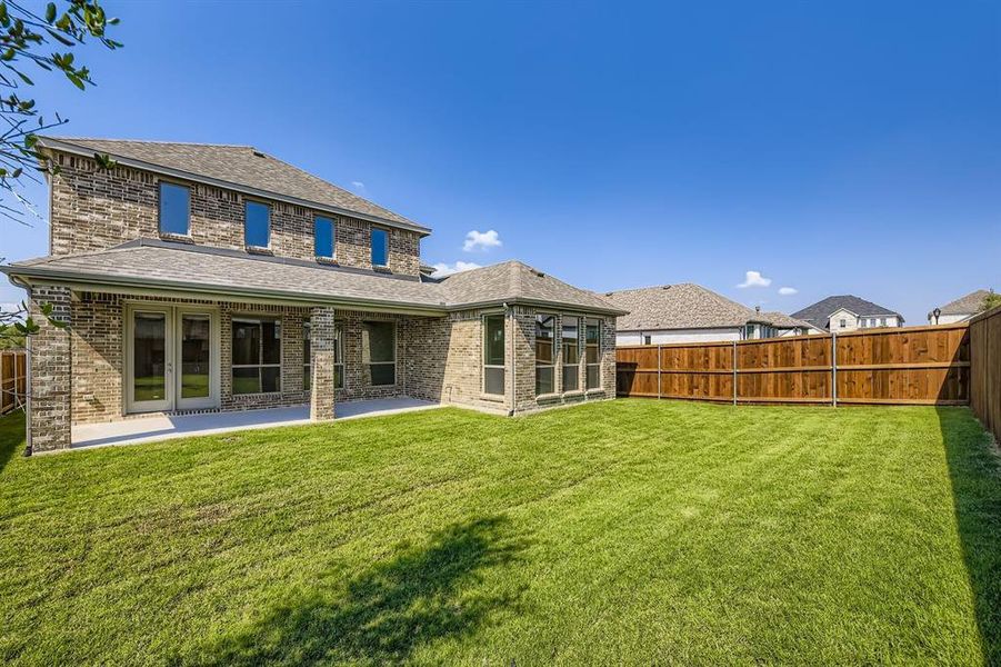 Back of house with roof with shingles, brick siding, a patio, and a fenced backyard Back of house with roof with shingles, brick siding, a patio, and a fenced backyard
