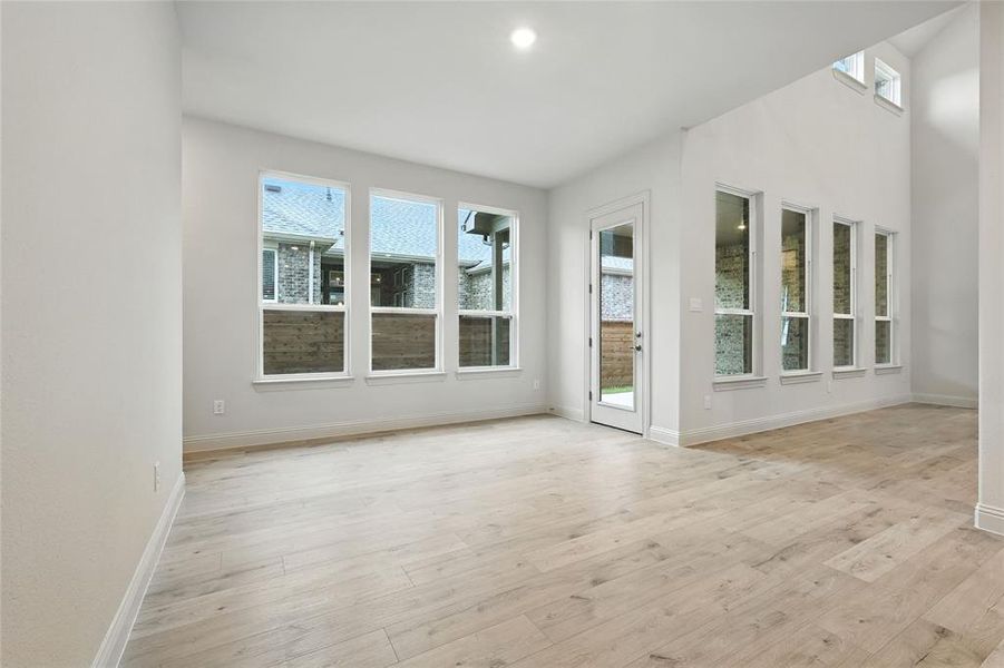 Unfurnished sunroom with wood finished floors and recessed lighting