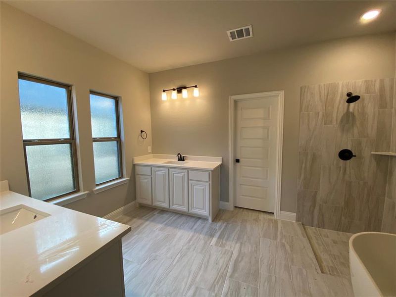 Spa-like master bathroom with oversized 12x24 grey tile