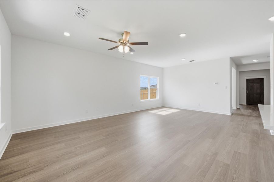 Unfurnished living room featuring recessed lighting, light wood-style flooring, and a ceiling fan Unfurnished living room featuring recessed lighting, light wood-style flooring, and a ceiling fan