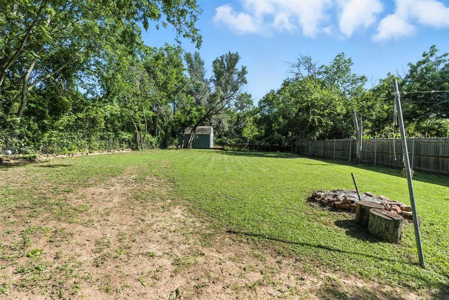 View of yard featuring a storage unit