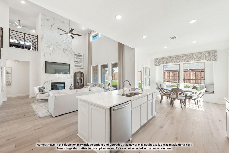 Open-concept kitchen with white island, marble fireplace wall, and dining area with high ceilings and hardwood floors Open-concept kitchen with white island, marble fireplace wall, and dining area with high ceilings and hardwood floors