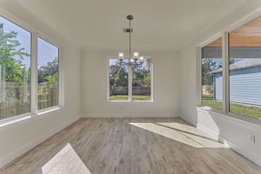 Incredible! The dining room is wrapped in sunlight with expansive windows in every direction. Imagine sipping your morning coffee with this view. Incredible! The dining room is wrapped in sunlight with expansive windows in every direction. Imagine sipping your morning coffee with this view.