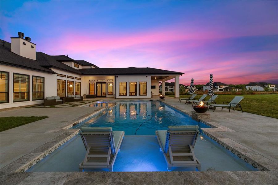 Another view of your beautiful backyard oasis. Treat yourself to the resort style atmosphere at your very own home with a unique, custom pool with a view. It's all blue skies back here!