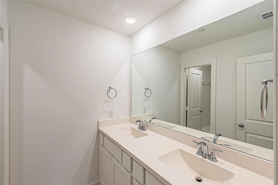 Bathroom featuring double vanity and recessed lighting
