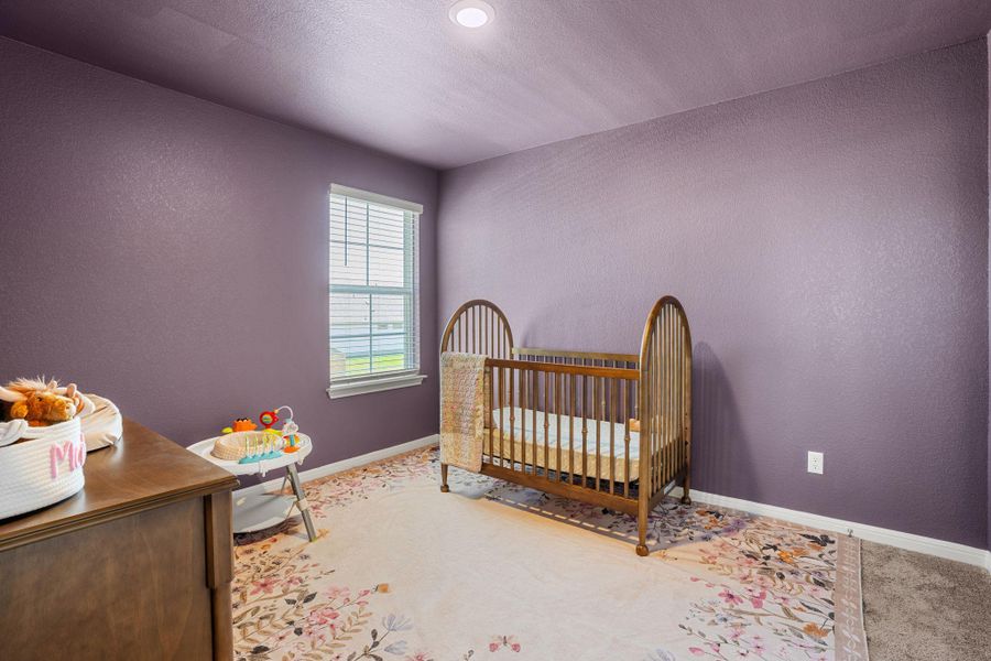 A well-lit bedroom offering ample space and a cozy atmosphere.