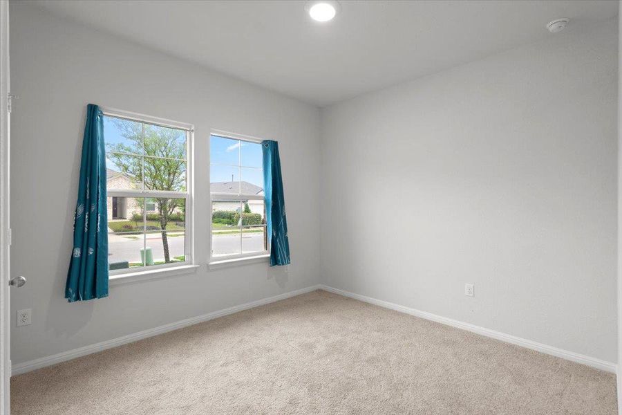 Carpeted room with two large windows, recessed lighting, white baseboards, and neutral wall paint