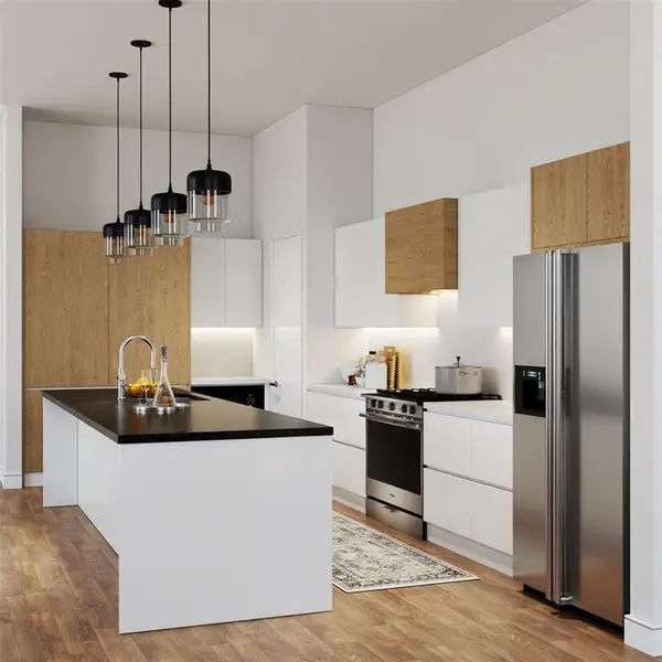 Kitchen with white cabinetry, stainless steel appliances, a center island with sink, hanging light fixtures, and light wood-style flooring