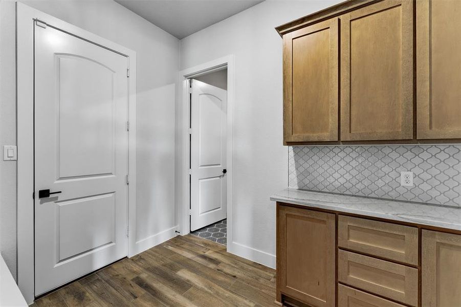 Hall featuring dark wood-type flooring and baseboards